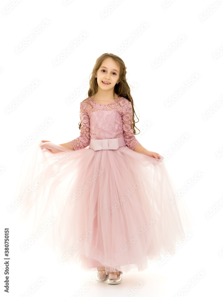 Little girl in an elegant dress.The concept of a happy childhood Little girl in an elegant dress.The concept of a happy childhood