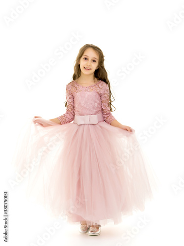 Little girl in an elegant dress.The concept of a happy childhood