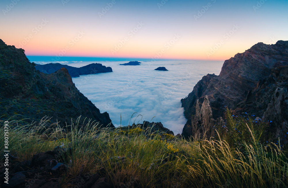 Breathtaking scenery of rocky hill and foamy sea under sunset sky in long exposure Breathtaking scenery of rocky hill and foamy sea under sunset sky in long exposure