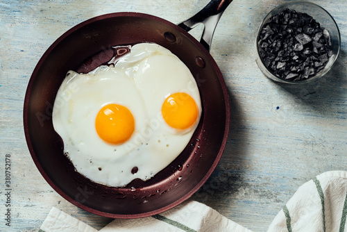 Fried egg. view of two fried eggs on a frying pan. ready to eat with breakfast or lunch photo