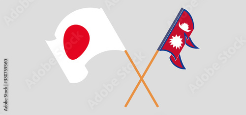 Crossed and waving flags of Nepal and Japan