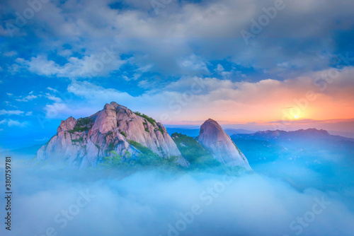 bukhansan national park covered by morning fog and sunrise at seoul, south korea.