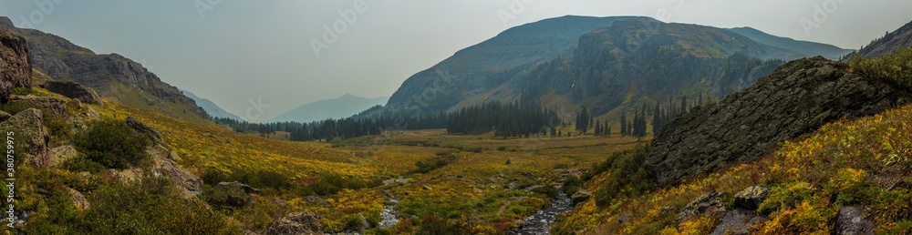 Panorama of the mountains in autumn with smoke haze