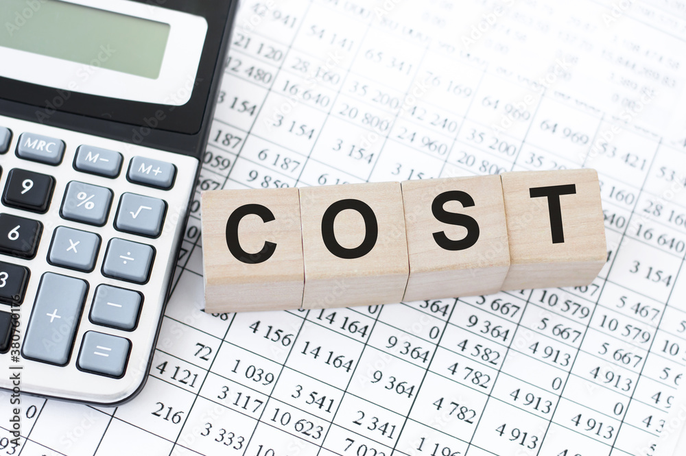 COST the word on wooden cubes on your desktop. Business and finance concept COST the word on wooden cubes on your desktop. Business and finance concept