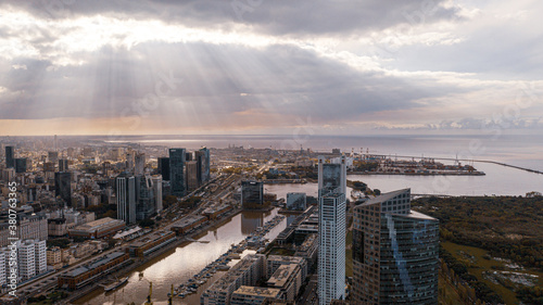 Aerial view of the Puerto Madero promenade with the Women's Bridge, Buenos Aires, Argentina.Sunset with sun rays and business buildings.