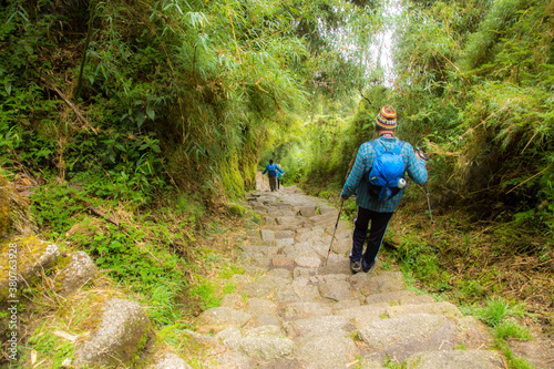 Hikers on the Inca trail near the Puyupatamarca archological site, Peru. Many of the stones in the trail were hand carved by ancient peruvians.