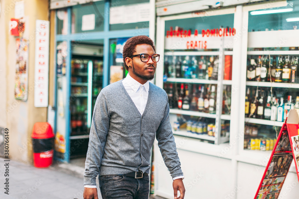 Black man on the street in front a liquor store. Black man on the street in front a liquor store.