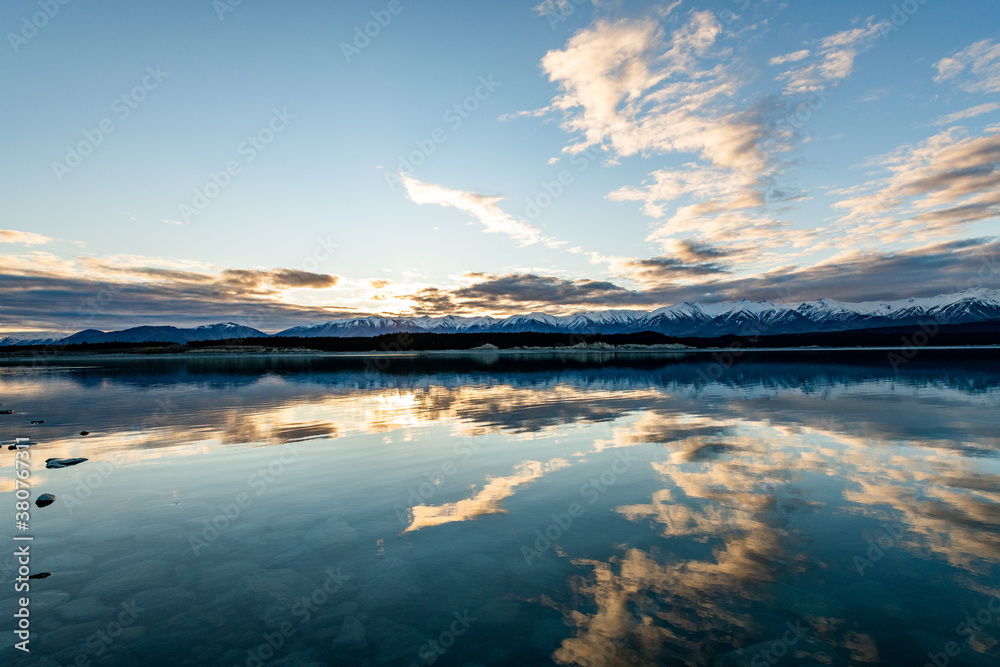 sunset over a lake with mountains in New Zealand