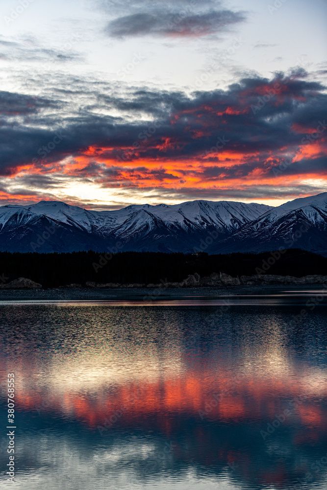 sunset over a lake with mountains in New Zealand