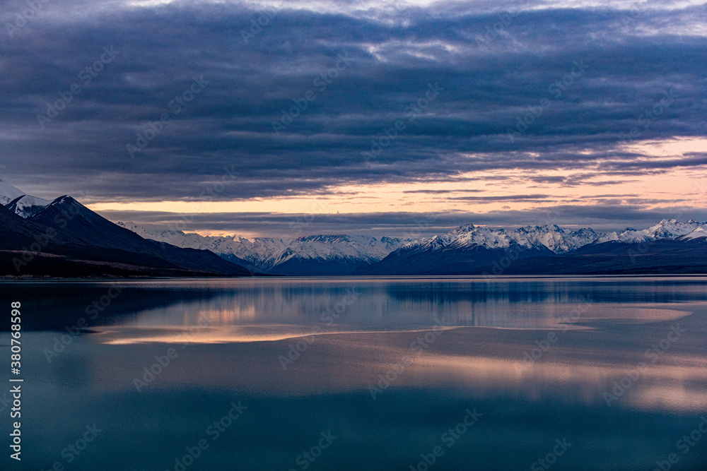 sunset over a lake with mountains in New Zealand
