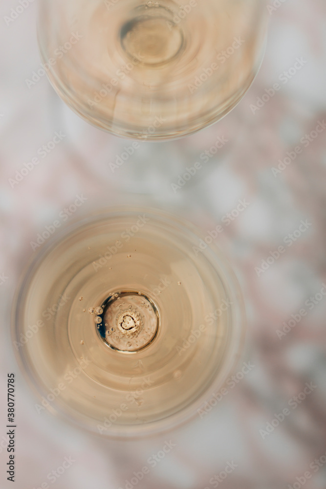 A couple of crystal glasses filled with champagne with a heart in the bottom A couple of crystal glasses filled with champagne with a heart in the bottom