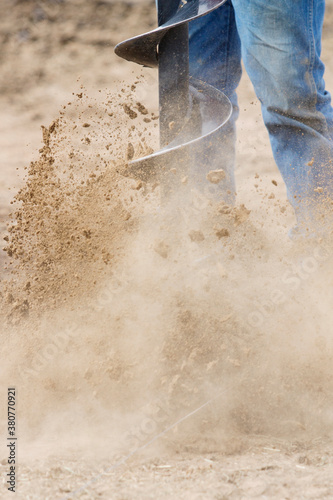 An auger throwing dirt