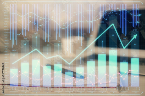 Double exposure of financial graph drawings and desk with open notebook background. Concept of forex market © peshkova