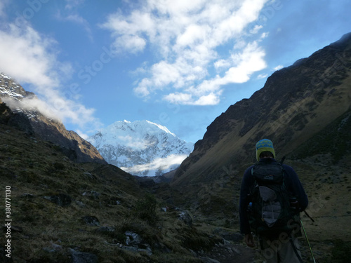 Hikers in the shadows on the Salkantay trek in Peru, with snow capped mountains in the distance
