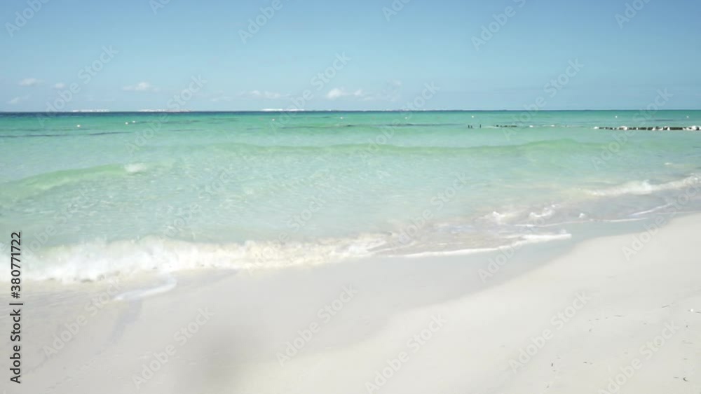 Sea waves breaking softly on the white sand of a deserted beach on a tropical island, Isla Mujeres, Mexico Sea waves breaking softly on the white sand of a deserted beach on a tropical island, Isla Mujeres, Mexico