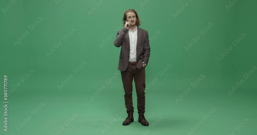 Studio, slow motion, green screen, a serious young man on the phone, London, UK Studio, slow motion, green screen, a serious young man on the phone, London, UK