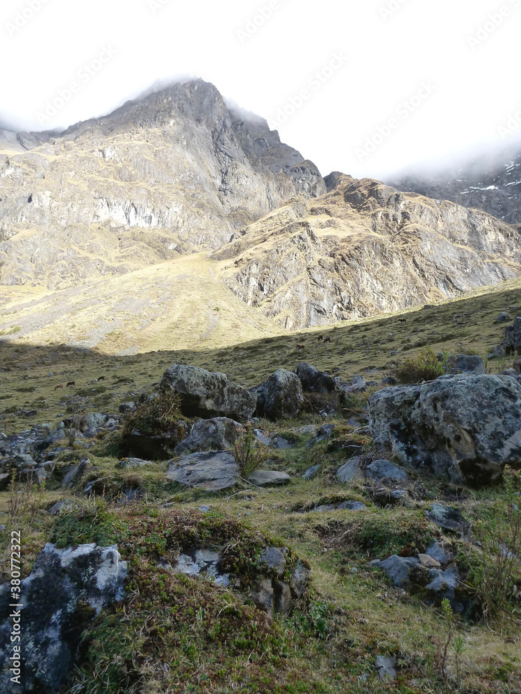 A scenic view of the rocky and mountainous terrain along the Salkantay trek in Peru A scenic view of the rocky and mountainous terrain along the Salkantay trek in Peru