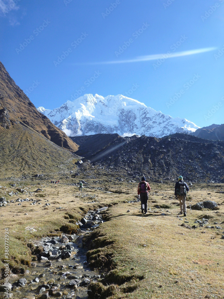 Hikers on the Salkantay trek in Peru, with snow capped mountains in the distance