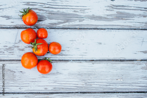 Tomatoes on white wood top view