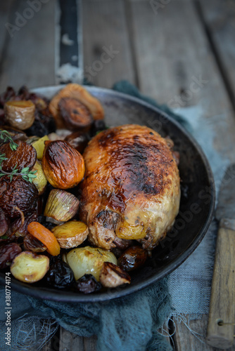 Roasted meat with onions, potatos and chesnuts photo