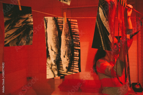 Woman working at home in a darkroom in the bathroom. photo