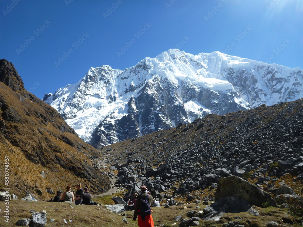 Fototapeta premium Hikers on the Salkantay trek in Peru, with snow capped mountains in the distance