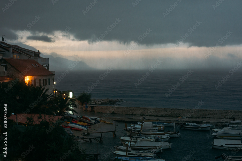 Rainy weather threatening clouds in a village by the sea Rainy weather threatening clouds in a village by the sea