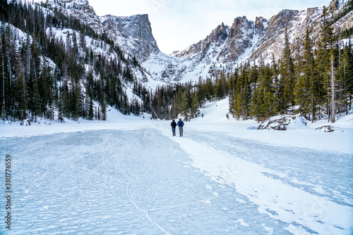Walking across a frozen lake in the winter on a cold day in Colorado's Rocky Mountains