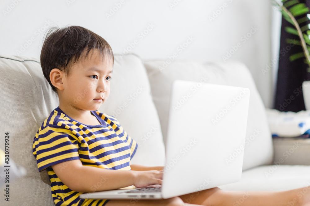 Asian toddler boy student study online learning online education video call zoom teacher.Happy boy learn english online with laptop at home.New normal.Covid-19 coronavirus.Social distancing.stay home. Asian toddler boy student study online learning online education video call zoom teacher.Happy boy learn english online with laptop at home.New normal.Covid-19 coronavirus.Social distancing.stay home.