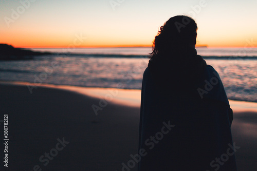 Woman looking at the sea in a cold morning