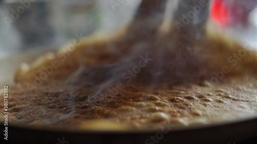 Frying Pancakes on Pan Releasing Lots of Smoke from Burnt Meal photo