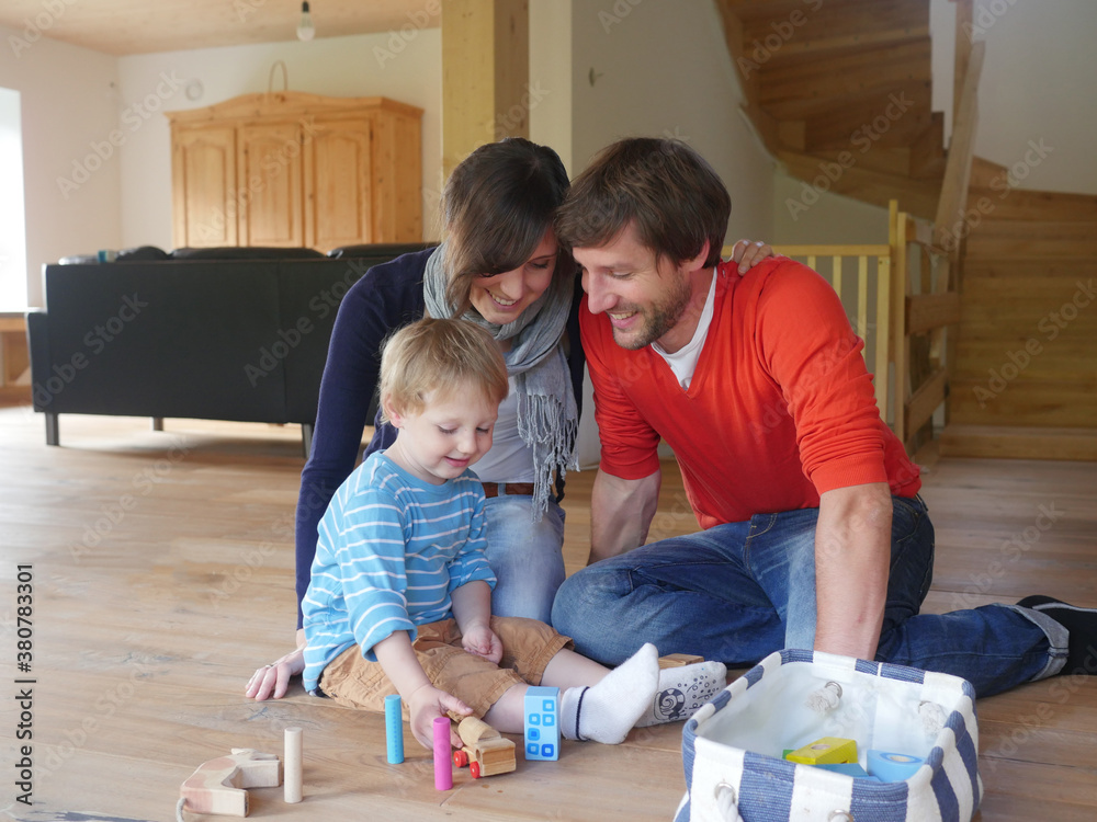 Family playing with child indoors Family playing with child indoors
