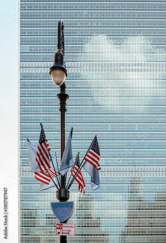 New York Street Lamp with American Flags against United Nations Building in Manhattan photo