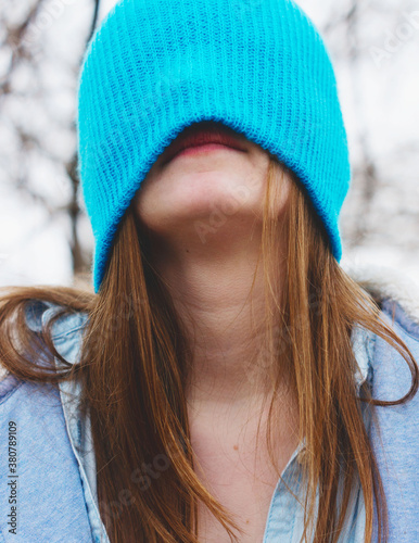 Teen partially hides her face under knit beanie