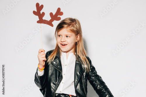 Cute Blonde Girl Holding Cardboard Reindeer Antlers photo