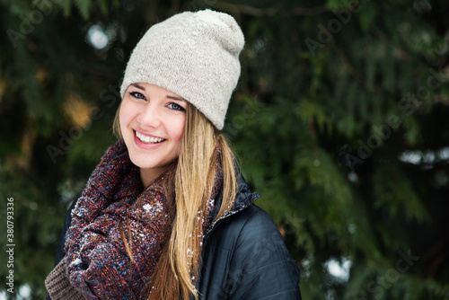 Portrait of a young woman smiling outside in the snow photo