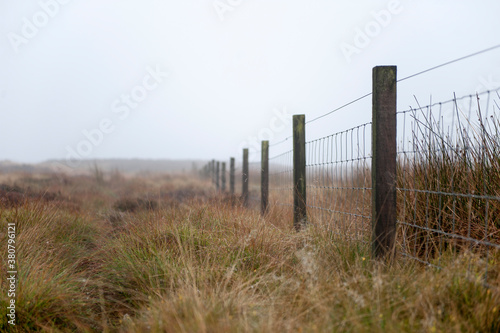 wire fence separating bleak moorland