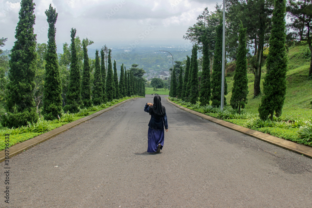 woman walking on the highway. a weekend getaway in a fresh garden woman walking on the highway. a weekend getaway in a fresh garden