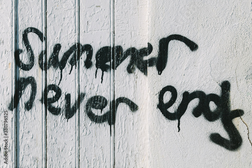 Summer Never Ends Messagge on a White Wall photo