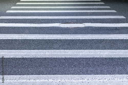 Close up of pedestrian crossing with a manhole cover