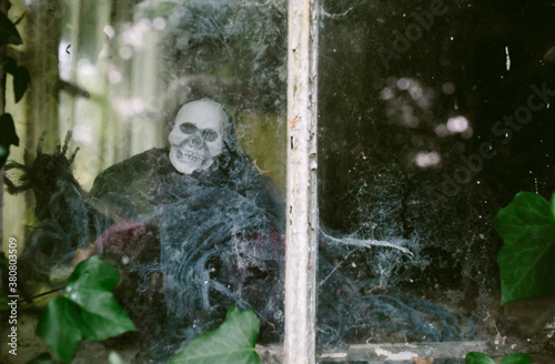 A ghoulish figure in an old window