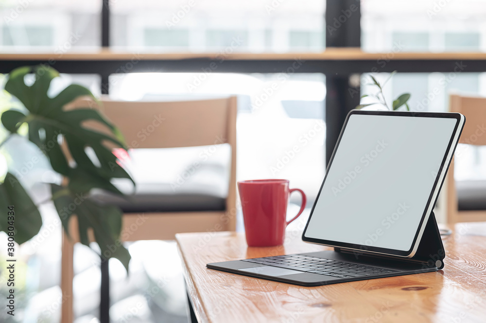 Mockup blank screen tablet with keyboard on wooden table in cafe, copy space. Mockup blank screen tablet with keyboard on wooden table in cafe, copy space.