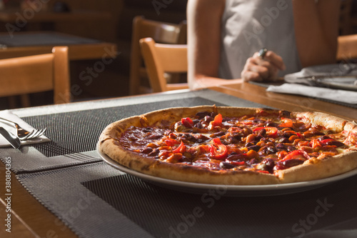 Closeup of an apetizing pizza on the table photo