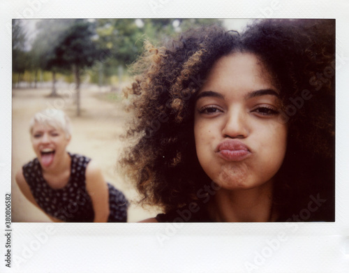 Self photo on polaroid of two joyful person photo