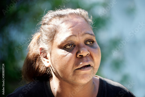 Aboriginal Woman on a Blurred Greenand Blue Background photo