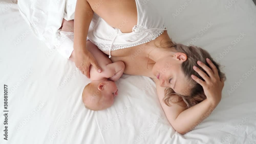 top view mother is lying with baby feeding breast milk. concept of breastfeeding top view mother is lying with baby feeding breast milk. concept of breastfeeding