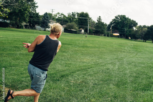 Male throwing a disc at a disc golf game photo