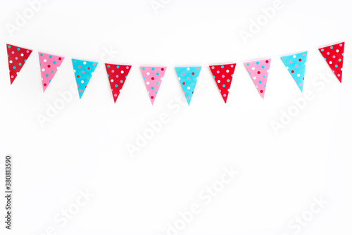 Party bunting against white wall with polka dots