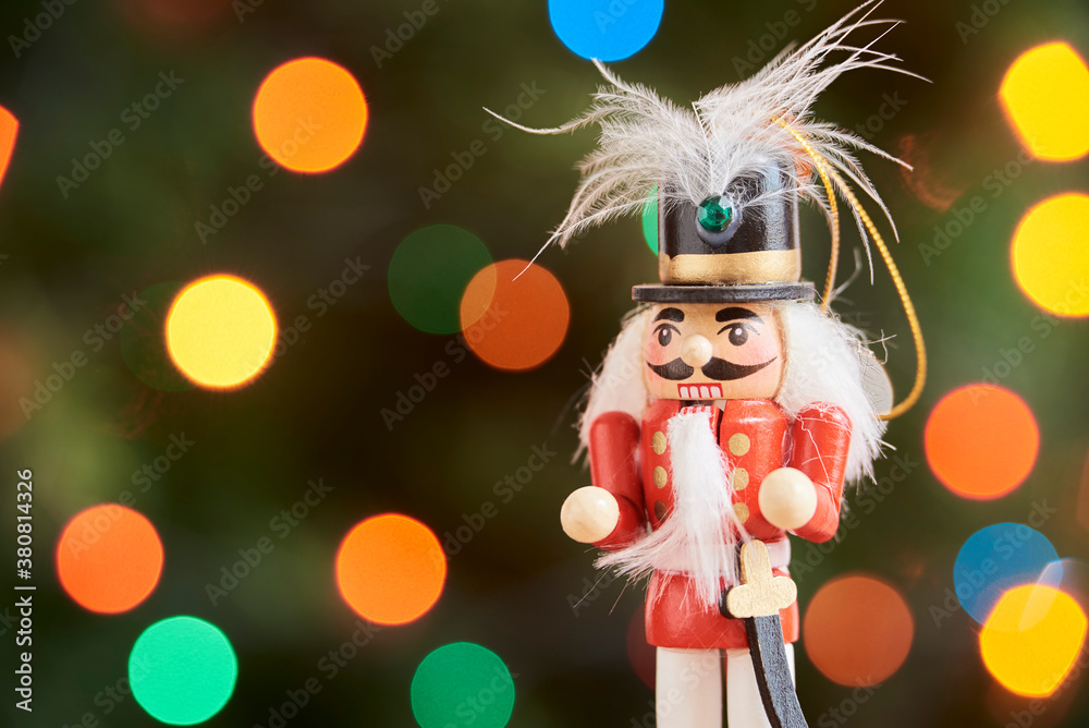 Traditional Christmas nutcracker with out of focus colored light background Traditional Christmas nutcracker with out of focus colored light background