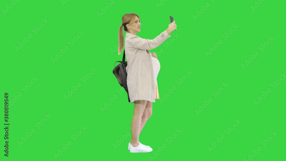 Happy young pregnant woman taking selfie on a Green Screen, Chroma Key. Happy young pregnant woman taking selfie on a Green Screen, Chroma Key.